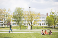 Students enjoy a warm May day by hanging out on the Green at Dartmouth College.