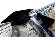 Hundred dollar bill with graduation cap on top of the image of Benjamin Franklin’s head