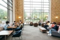 Wide shot of college students working in a student center