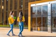 Two woman walking on a college campus