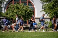 Students walk on Montclair State University’s campus on a sunny warm day
