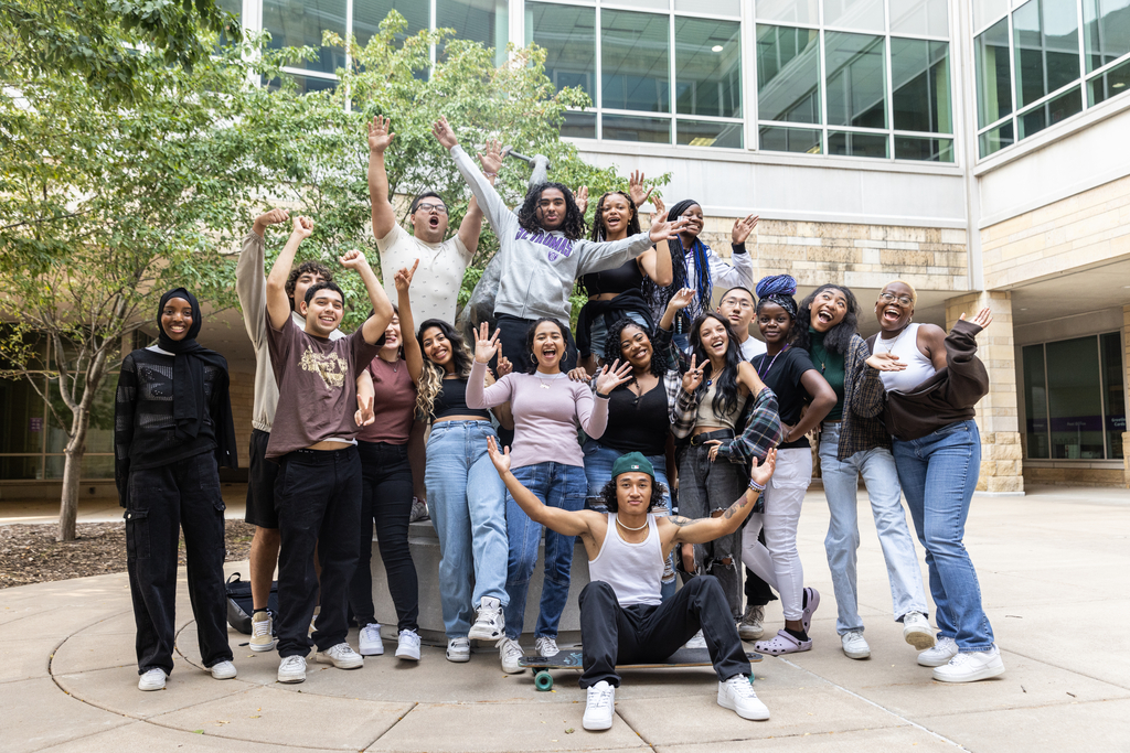 Students smile outside the University of St. Thomas