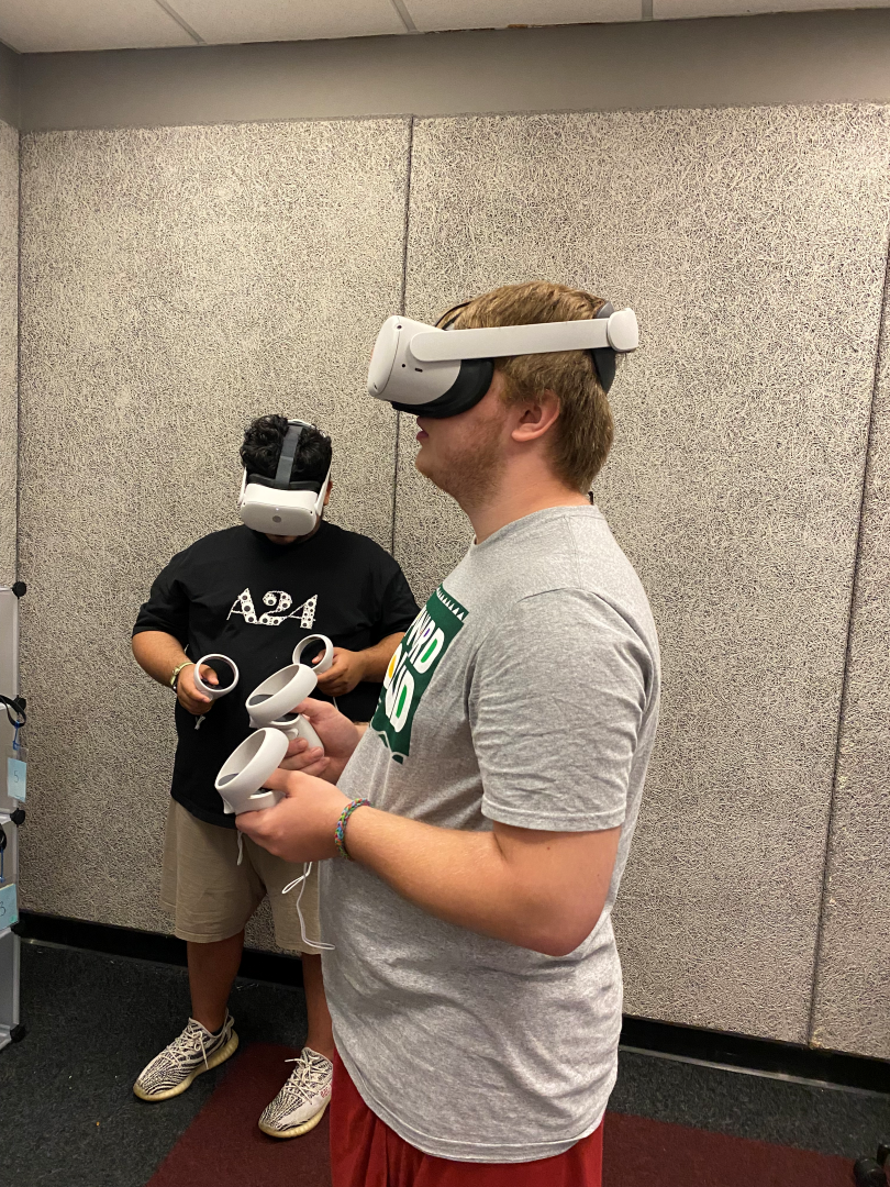 Two students wear VR headsets within IUPUI's Speaker's Lab