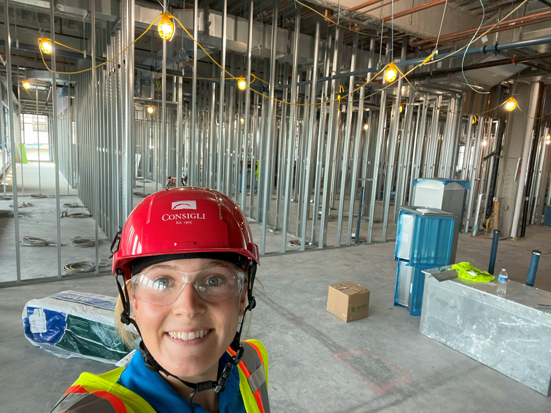 Julia Danko, wearing a hard hat, safety glasses and a high-visibility vest, works on one of the two lab space fit-out projects as a Field Operations intern for Consigli.