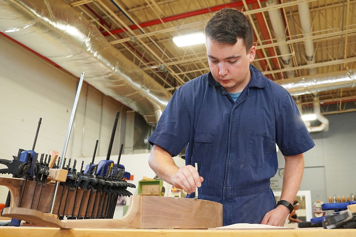 Evan Sturgill build a guitar as part of his job in Berea’s Student Craft program.