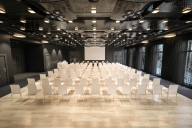Huge, glossy conference room with dozens of empty chairs