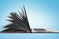 Concept photo of an open gray laptop on the right that opens up and becomes a book with pages on the left. Background is blue. 