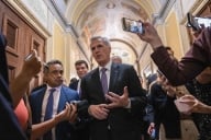 Speaker Kevin McCarthy surrounded by reporters holding smartphones