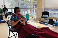 Two students receive Reiki at Bowdoin college.