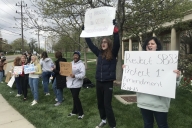 Students holding signs in opposition to Ohio Senate Bill 83