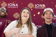 Five students in Iona gear smile in front of a burgundy Iona backdrop.
