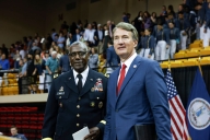 A photo of VMI superintendent Cedric Wins, who is Black and wearing a military uniform, and Virginia governor Glenn Youngkin, who is white and wearing a business suit and red tie, standing together