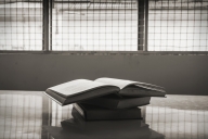 A stack of books in a prison room.