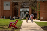 Students walk on York College's campus on a sunny day.