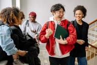 A group of students interact in a hallway.