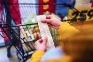 Student looks at long grocery bill