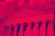 Facade of U.S. Supreme Court with a red-colored filter applied.