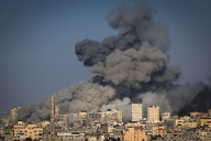 An overhead view of smoke billowing over Gaza City in the aftermath of Israeli air strikes. 