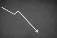 A white line graph against a black background depicting a sharply downward trend.