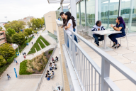 Students loiter outside the University of Missouri at Kansas City student union on the patio and on the second-floor patio.