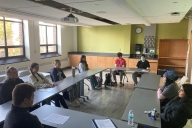 A group of Le Moyne students sit at desks