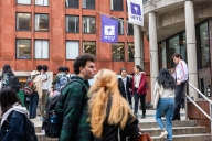 Students walk around New York University campus