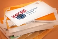 A photo illustration of a stack of bills with a past due notice.