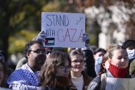 A group of students protesting. One holds a sign that reads, "stand with Gaza."