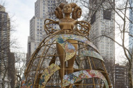 The sculpture "Witness," which shows a towering, golden female figure with a judicial collar and thick braids resembling ram horns.