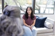 While attending college away from home, a seemingly frustrated young adult female sits with the counselor to talk about her emotions.