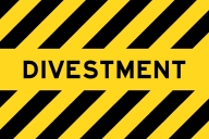 A yellow banner with black stripes bearing the word “divestment” in all capital letters.
