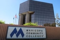 A sign reads “Maricopa Community Colleges” in front of an administrative building.
