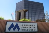 A sign reads “Maricopa Community Colleges” in front of an administrative building.