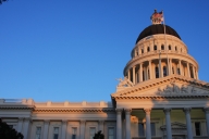 The California legislature building is toward the right of the photo. There are slight shadows across the building 