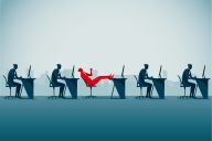 Series of blue figures working at desks, with one red figure slouching back in seat not working