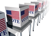An illustration of a row of empty voting booths, each with an American flag and the word "VOTE," lined up on tables.