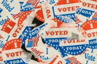 Photo of many ripped and tattered "I voted today" stickers.