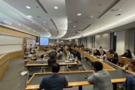 Students sit in lecture hall for constructive dialogue event