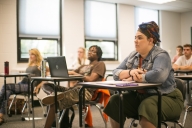 Students sit at desks in an Erie County Community College classroom. 