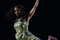 A woman in a green dress dances