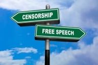 Two road signs on a pole: one, with the words "Free Speech," points to the right, while the other, with the word "Censorship," points to the left.