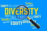 A word cloud made up of the words "Diversity," "Equity" and "Inclusion" with a magnifying glass lying atop it.