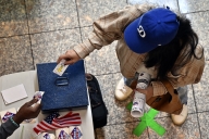 A woman returns her voter card after casting her ballot inside the Galleria at Sunset mall on Nov. 5, 2024, in Las Vegas.