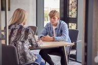 College student having individual meeting with tutor