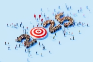 Human crowd surrounding 2025 and red bull's-eye target object on blue background. 