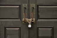 A photo of a door that is chained shut and locked.