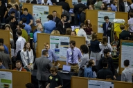 Students present papers and are surrounded by spectators