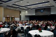 Faculty and staff at DePaul University listen to a speaker in a large conference room.