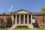 Bethesda campus of the National Institutes of Health with the main historical building (Building 1) at the focus. It is a sunny spring day.