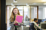Happy young paralegal walking through the office